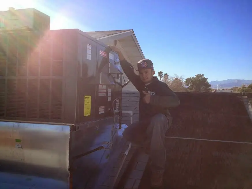 HVAC technician performing HVAC Inspection on a rooftop unit in Grove City